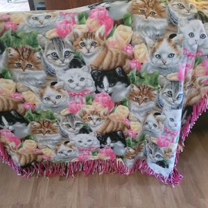 Cats, cats, and more cats and some bright pink fleece make up this snuggly throw